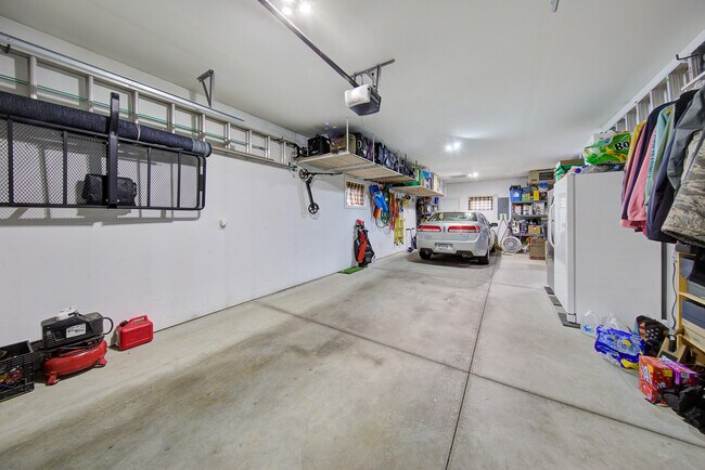 Tandem garage with overhead mounted hanging storage racks (250 lb capacity) - 2163 Rolling Green Ln