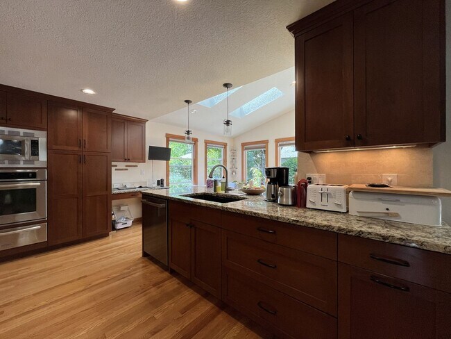 Building Photo - Bright and Open 4 Bedroom Cedar Mill Home with Vaulted Ceilings, Skylights & Multiple Living Areas