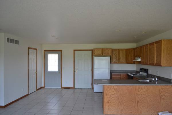 Kitchen with front half bath door, front door and garage door - 610 N Aspen Ct