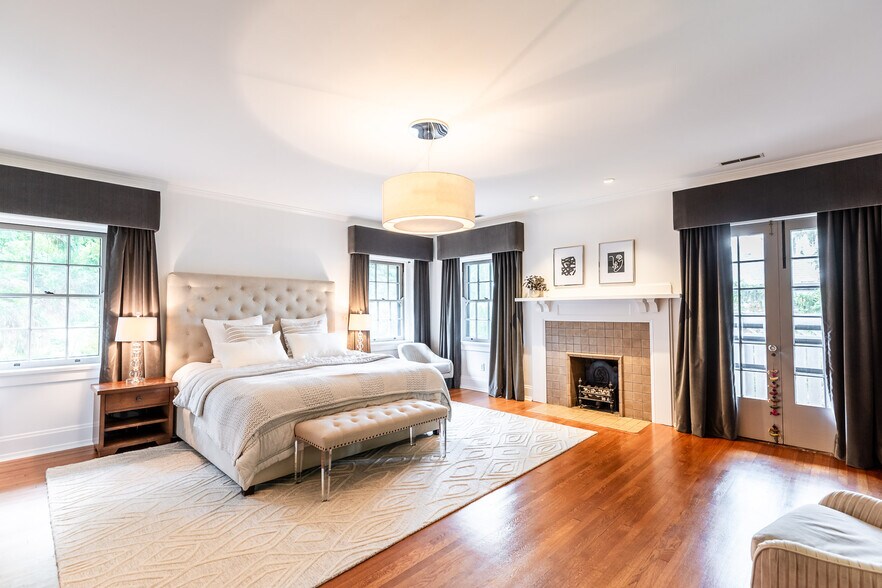 Sophisticated primary suite with fireplace and terrace. - 4061 Beechwood Ave