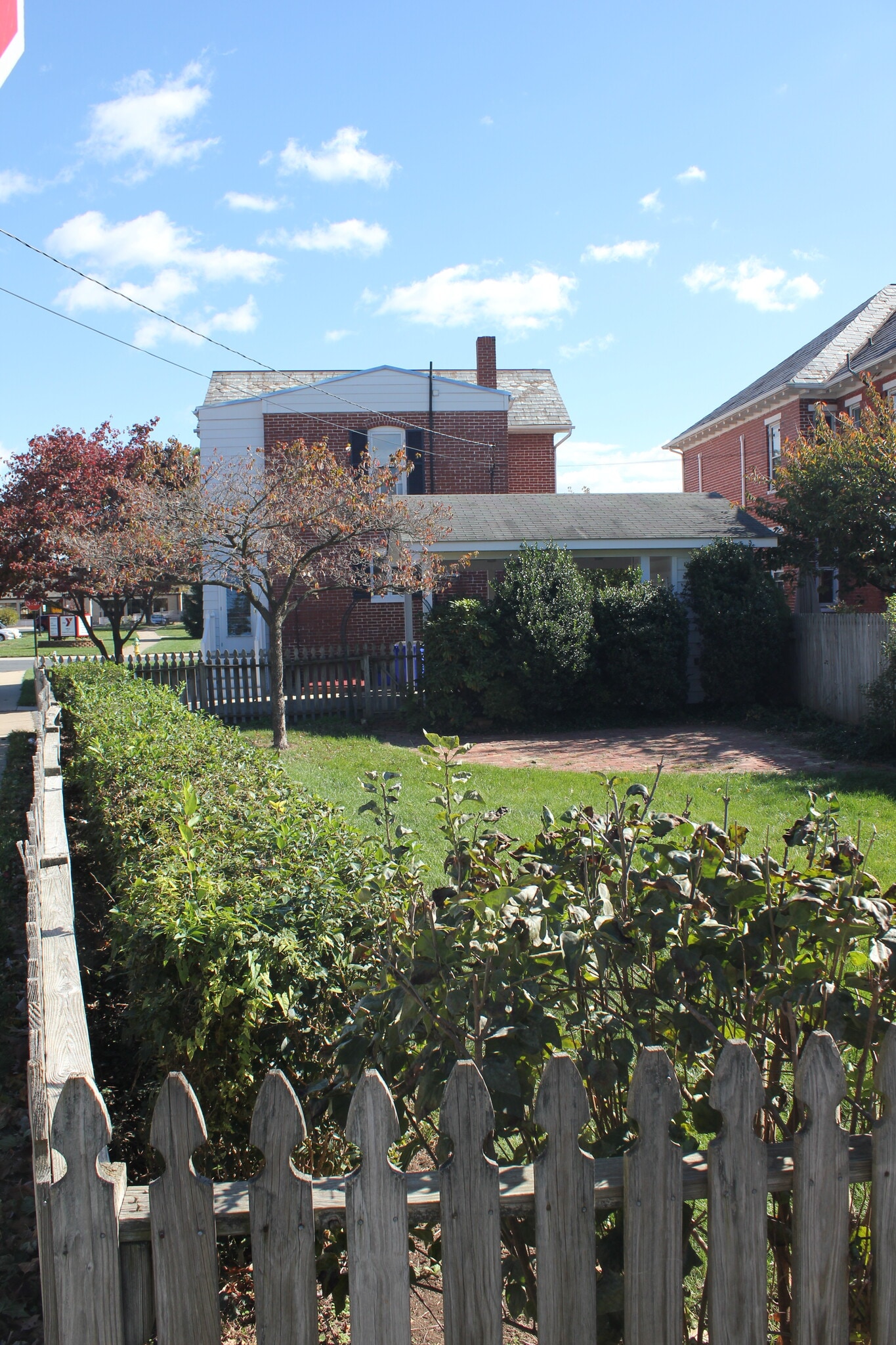 View from far end of backyard toward the car port and rear of the house. There is a brick patio in the back yard. - 925 North Market Street