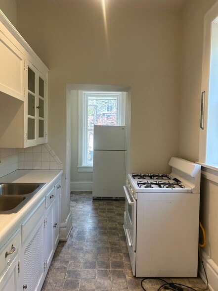 Kitchen with gas stove and refrigerator. - 1688 E Broad St