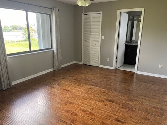 Primary bedroom has large picture window overlooking the canal and large yard. - 2321 SE 5th Ct