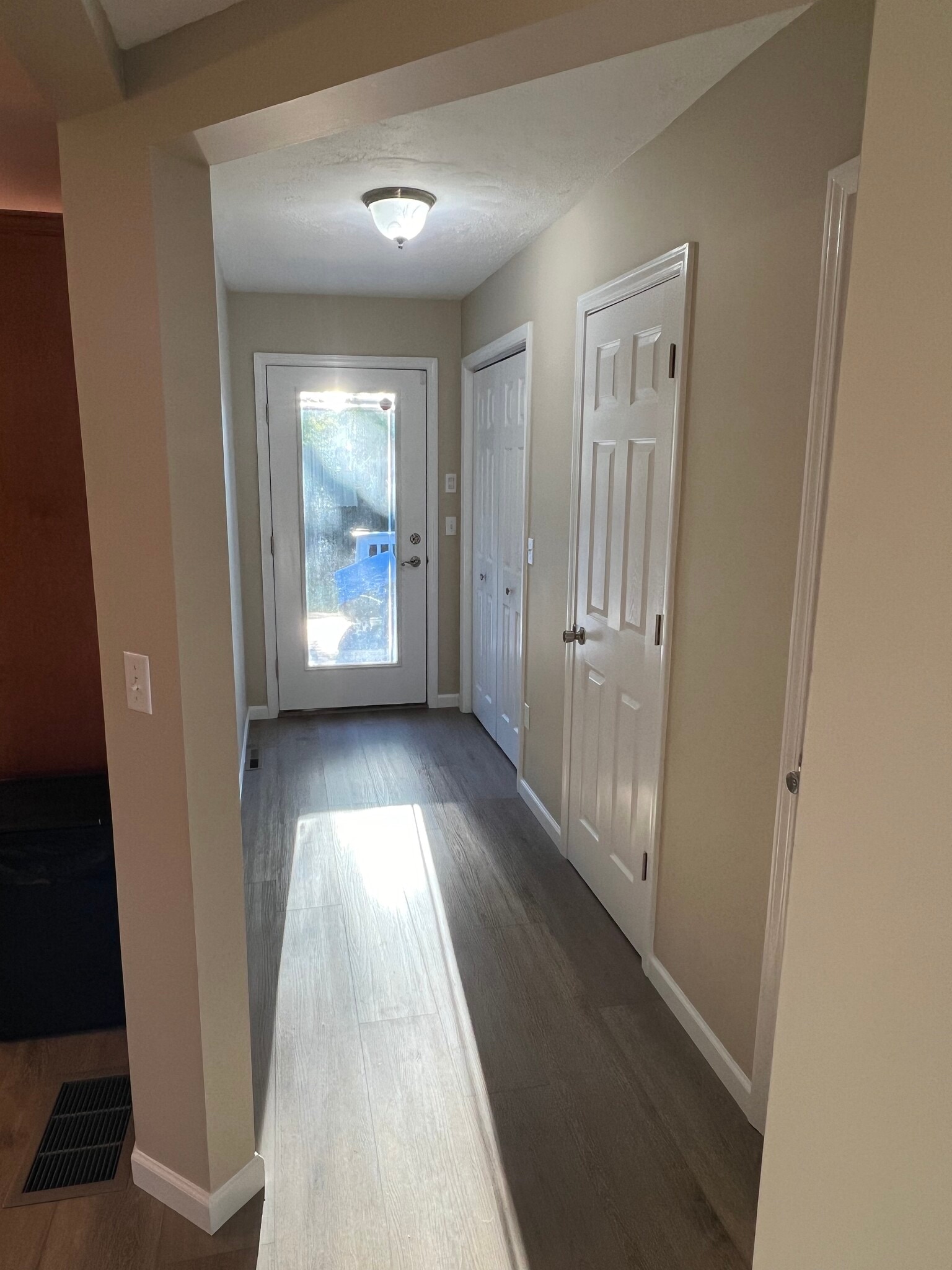 Pantry/broom closet, half bathroom, coat closet, and door to the back deck. - 176 Duer St