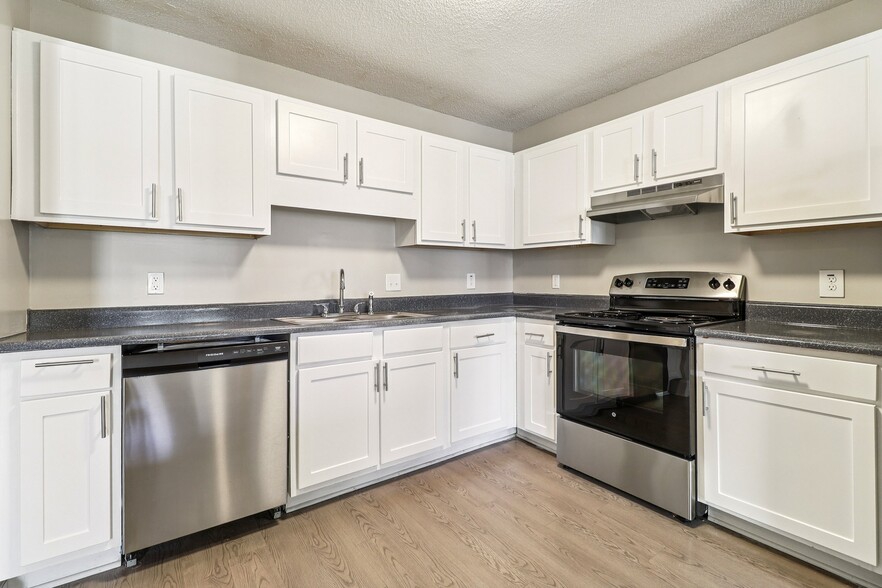 Prepare meals in style with white cabinets and quality stainless steel appliances, professionally operated by Highlands Vista Group. - Avalon Place