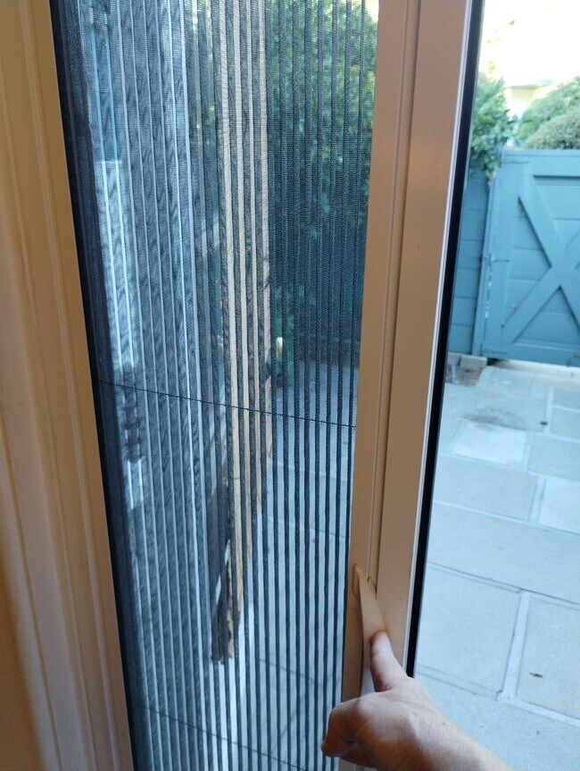 Retractable screen door on back door - 5273 Village Grn