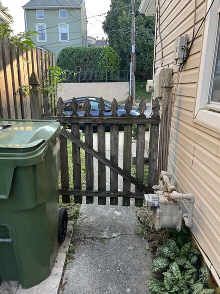 Inside the front gate is a pad for the trashcan and recycling bin. - 126 Merion Ave