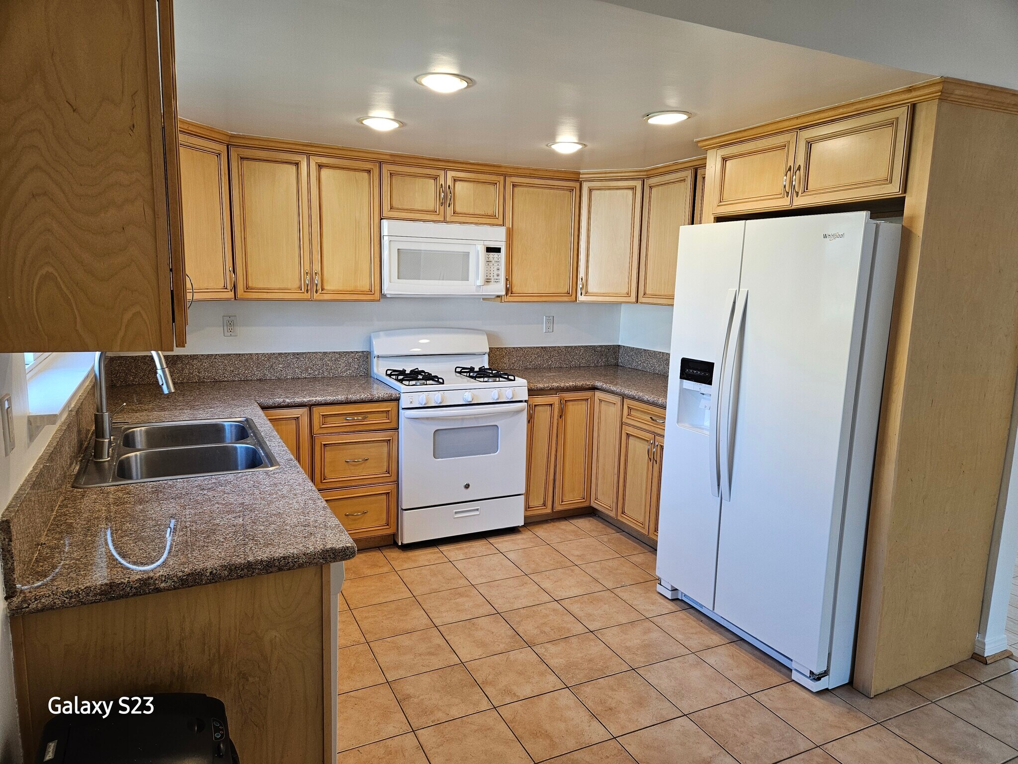 Kitchen complete with range/oven, new refrigerator, microwave, and dishwasher. - 1344 E Windsor Rd
