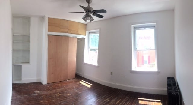 3rd Floor Front bedroom (12' x 14') Fits queen bed. Full sized double closet and built-in bookshelf. - 1229 E Susquehanna Ave