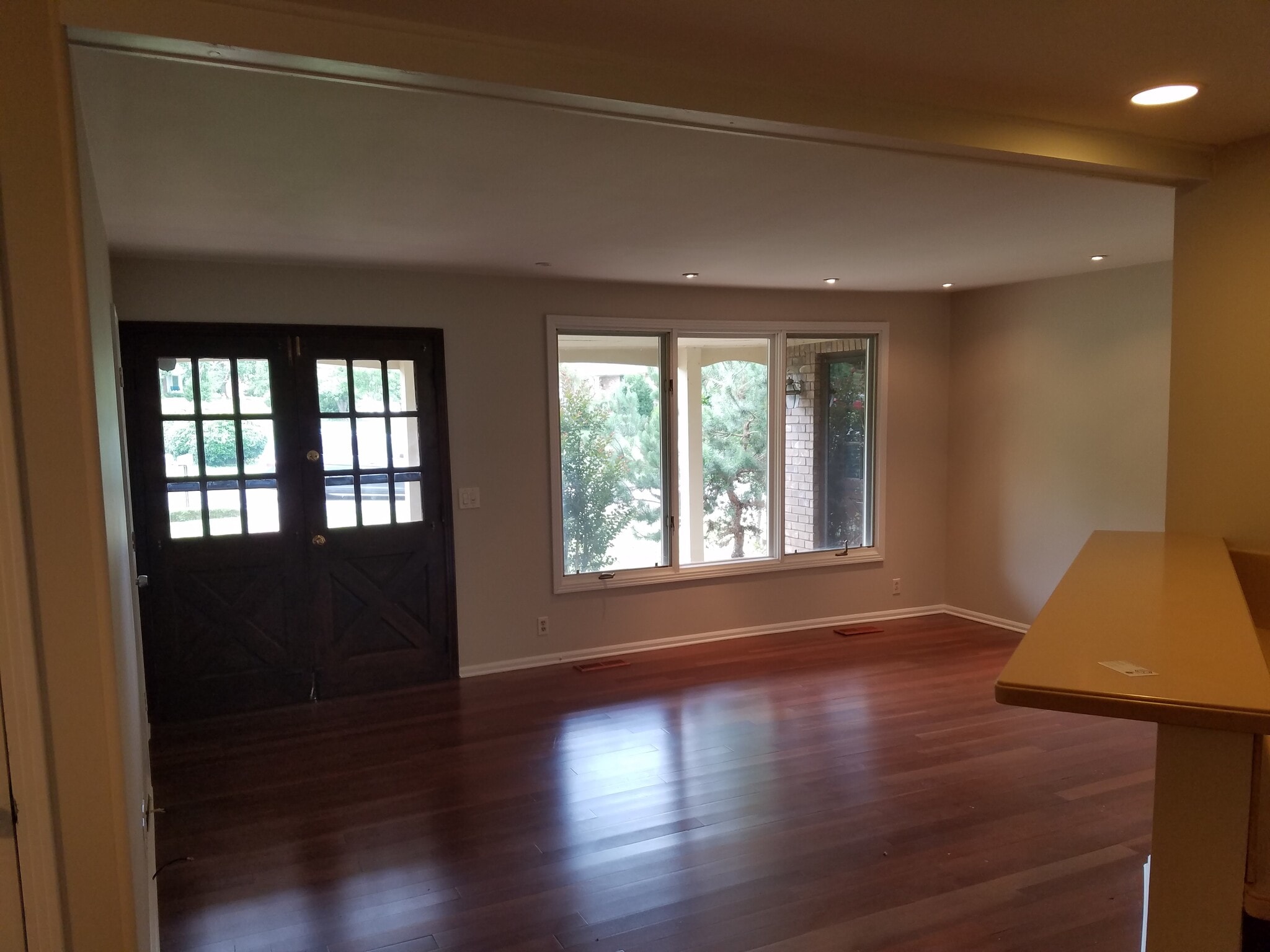 Living room with double front door and big windows allowing lots of natural light. - 665 Harpeth Bend Dr