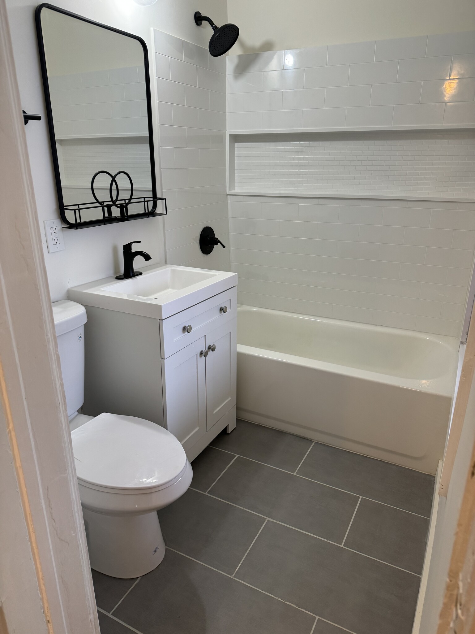 Newly renovated bath boasts new tile flooring, vanity, shower, toilet and accessories - 118 Philip St