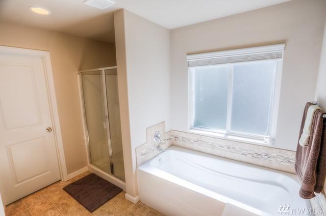 Master bath, double sinks, and large walk in closet. Linen closet in master bath as well. - 8828 Jayden Ln NE