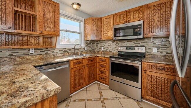 Building Photo - Now Ready : 4BR, 1 1/2BA home with fenced in back yard and storage building.