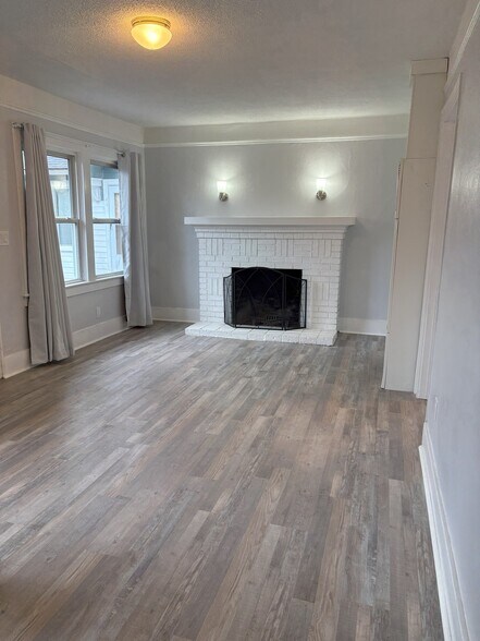 living room with wood burning fireplace - 445 16th St SE
