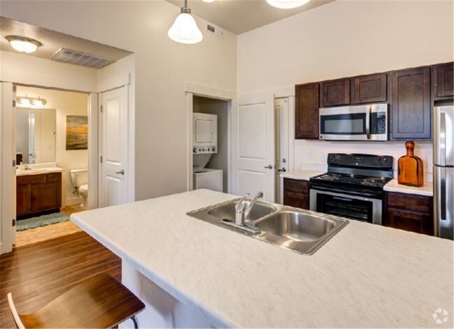 Kitchen view with washer and dryer. - West Station Apartments