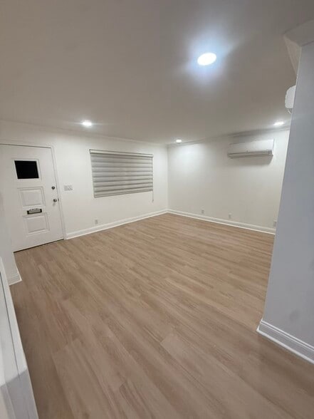 Bright living area with recessed lighting, mini split & new floors - 1120 50th St