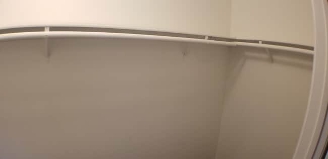 Walk-in closet with wrap around shelving and hanger rods - 14365 Foothill Blvd