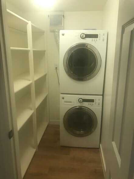 Laundry room with additional shelving for pantry or storage. - 587 HILLSIDE DR