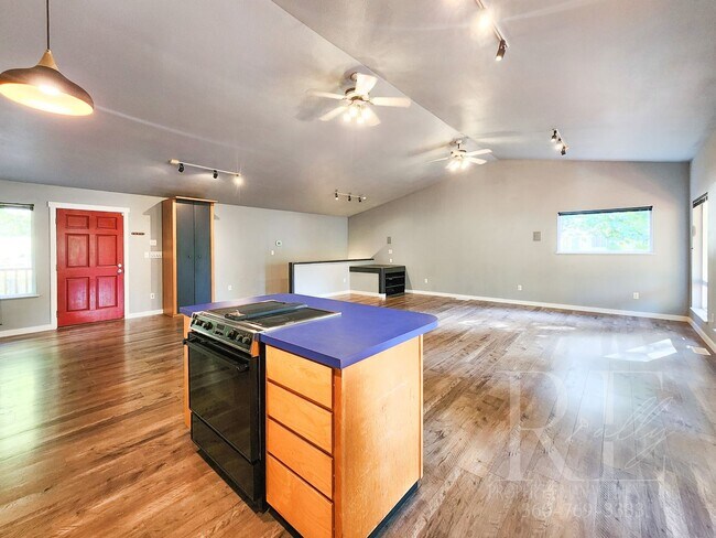 Building Photo - Vaulted Ceilings, Unique Designer Kitchen & Expansive Half-Acre Setting with Flexible Living Spaces