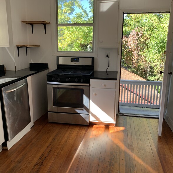 Kitchen with Gas Stove looking out to back por - 3639 Amberson Ave