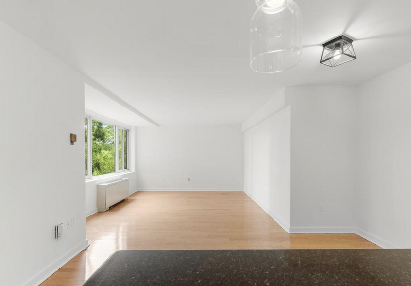 Spacious Living Room – Sunlit, open-concept space with hardwood floors. - 4000 Tunlaw Rd NW