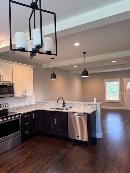 Beautiful open kitchen/dining looking into the open living room area - 100 Storytown Vlg