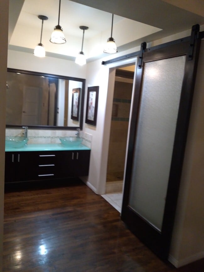 En suite with custom sliding barn door. - 6601 Louise Ave