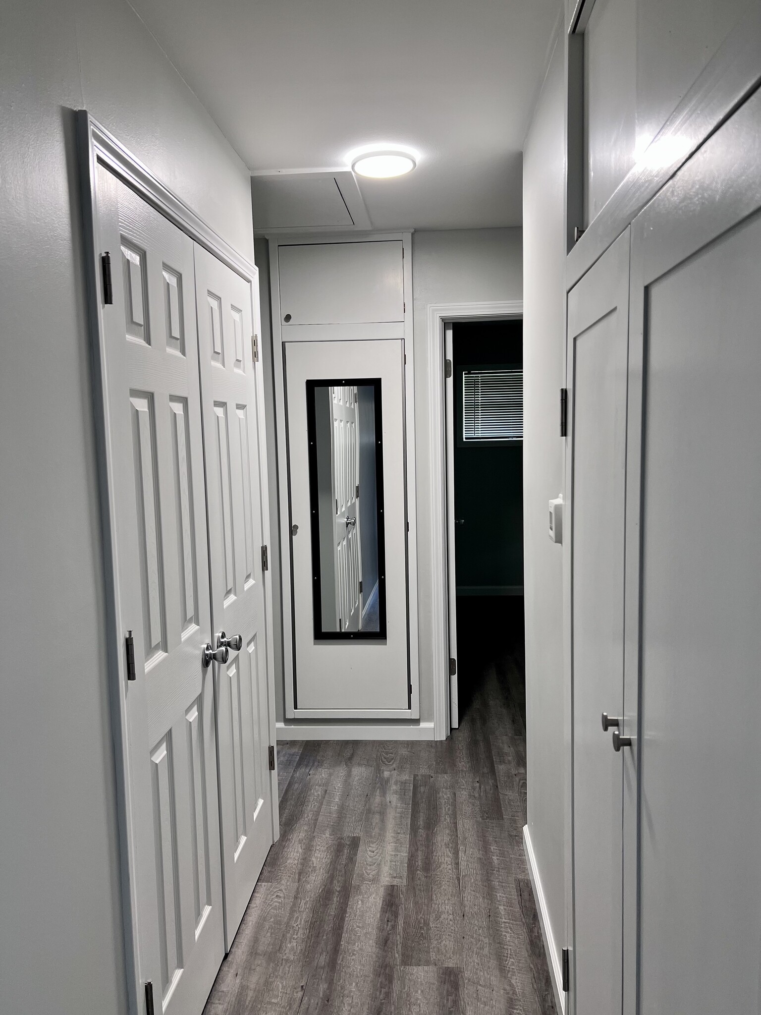 hallway to bedrooms with coat and linen closets - 1247 Dennis Dr