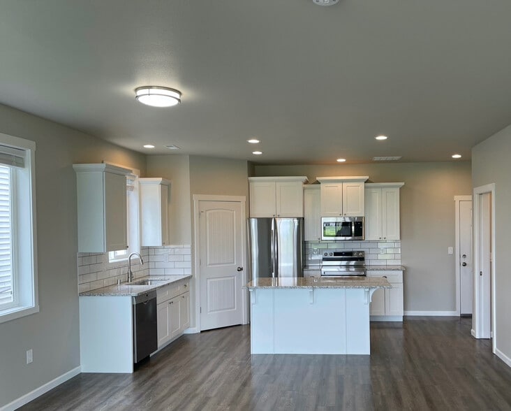 Kitchen from dining area - 9010 W Winona Rd