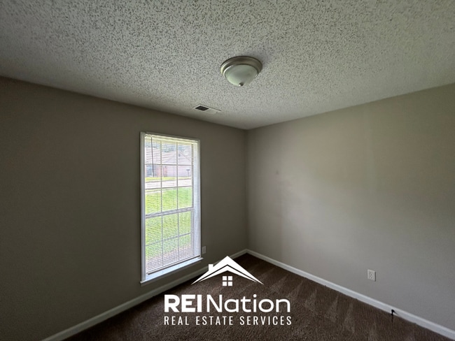Building Photo - Spacious 4BR/2BA Near Southwind | High Ceilings, Brick Fireplace & 2-Car Garage