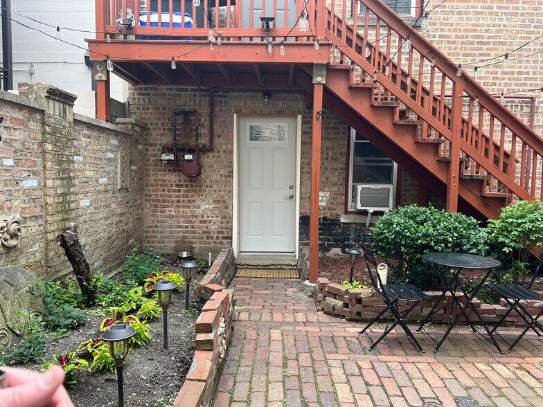 view of coach house apartment door from courtyard - 2446 W Thomas St