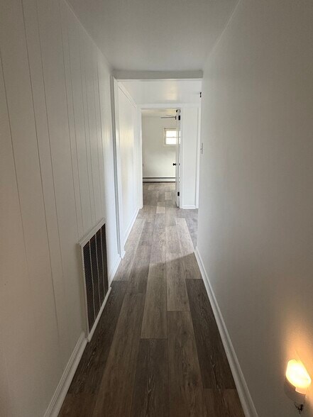 Long hallway leading to bedrooms and flex space - 318 N 4th St