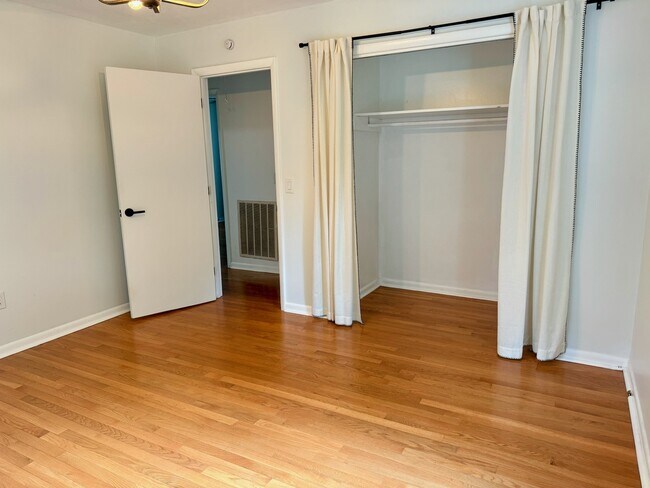 Primary bedroom with large closet with curtain doors - 6111 Northlakes Dr