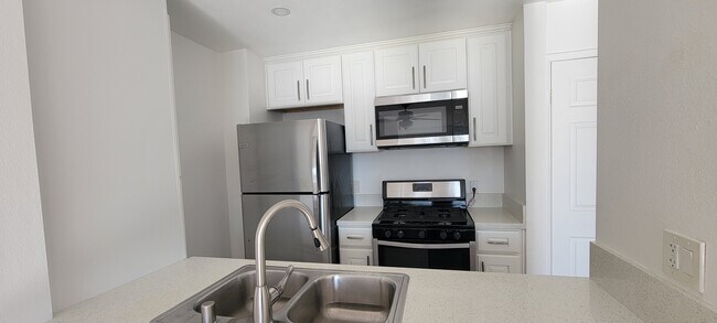 Kitchen with new stainless steel appliances - 14126 Tiara St