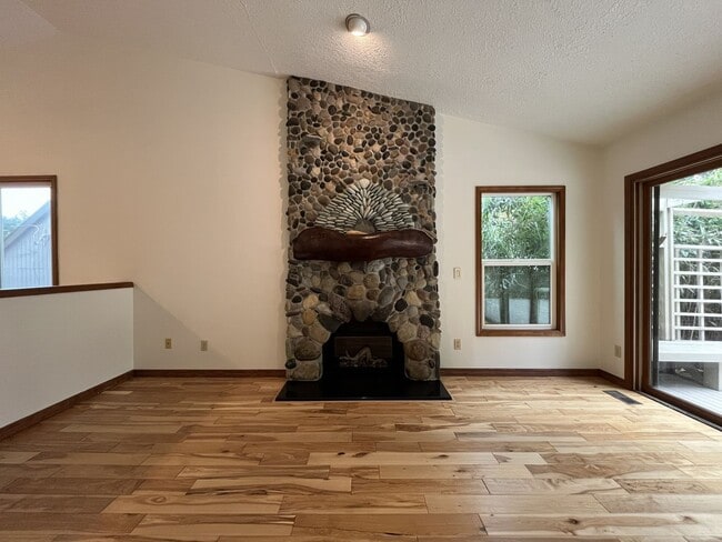 Building Photo - Spacious 3-Bedroom Home with Custom Stone Fireplace, Attached 2-Car Garage & Expansive Backyard i...