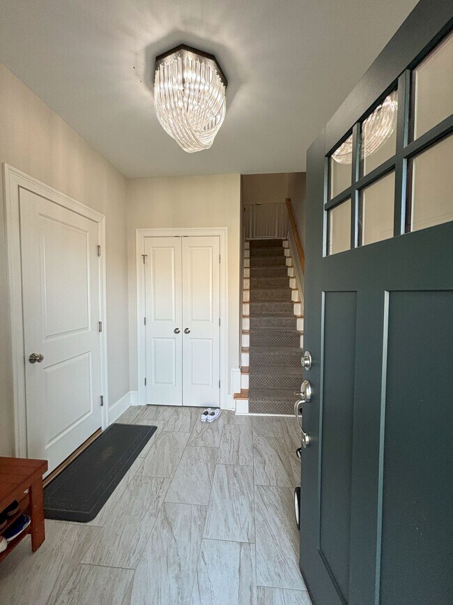 Entrance with access to garage and closet. Stairs to the main level. - 140 Wells View Rd