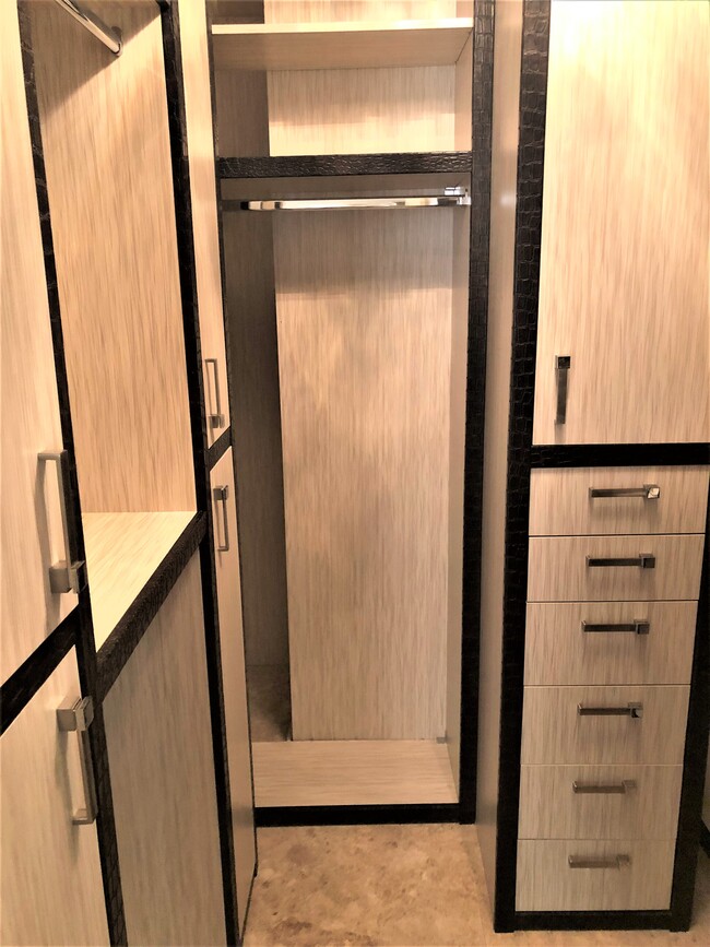 Master Closet with custom cabinets. - 15901 Collins Ave