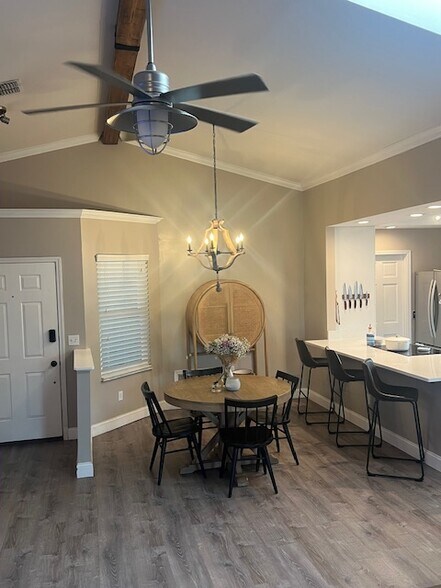 Open dining space with modern chandelier and natural light. - 953 13th Ave S