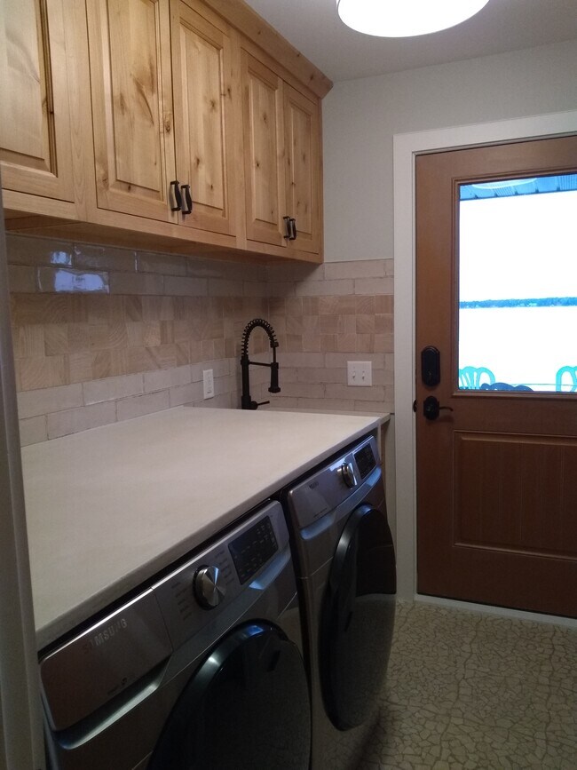 large laundry with sink and folding area - 21253 Lake George Blvd