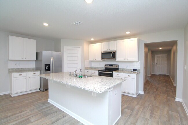 Building Photo - Coming Available Soon – 4BR/2BA Brick Home with Open Floor Plan, Solar Panels & 2-Car Garage in L...