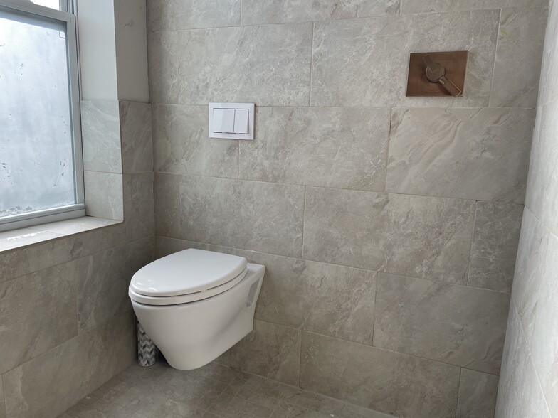 The second bathroom is European style with a toto tankless toilet and a shower juxtaposed. The entire room is tiled.d - 1003 P St NW