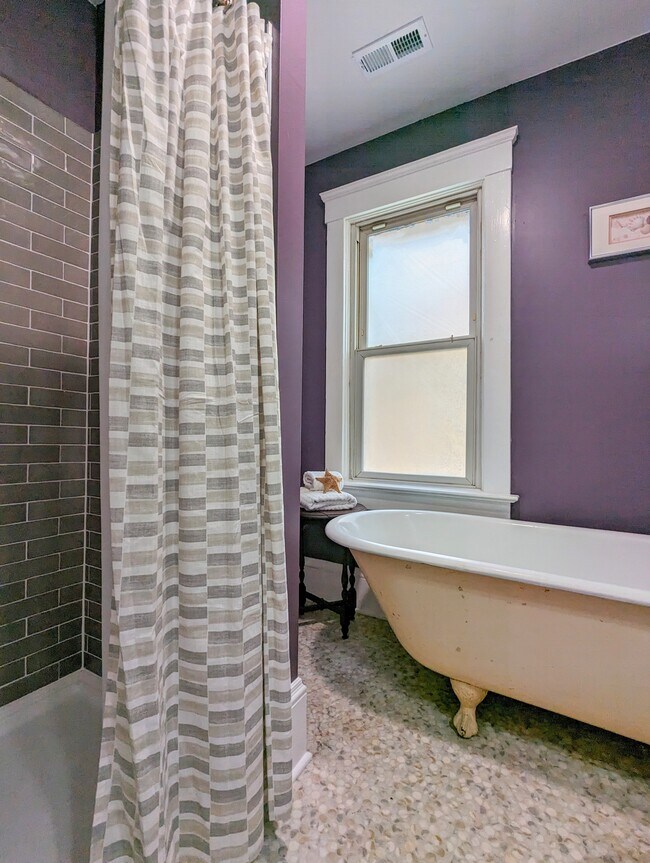 Main bath with tiled shower and clawfoot tub - 7216 W Clinton Ave