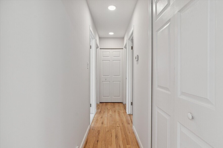 Hallway to 3 bedrooms and main floor bathroom + 2 hall closets for storage. - 9244 Northern Ave