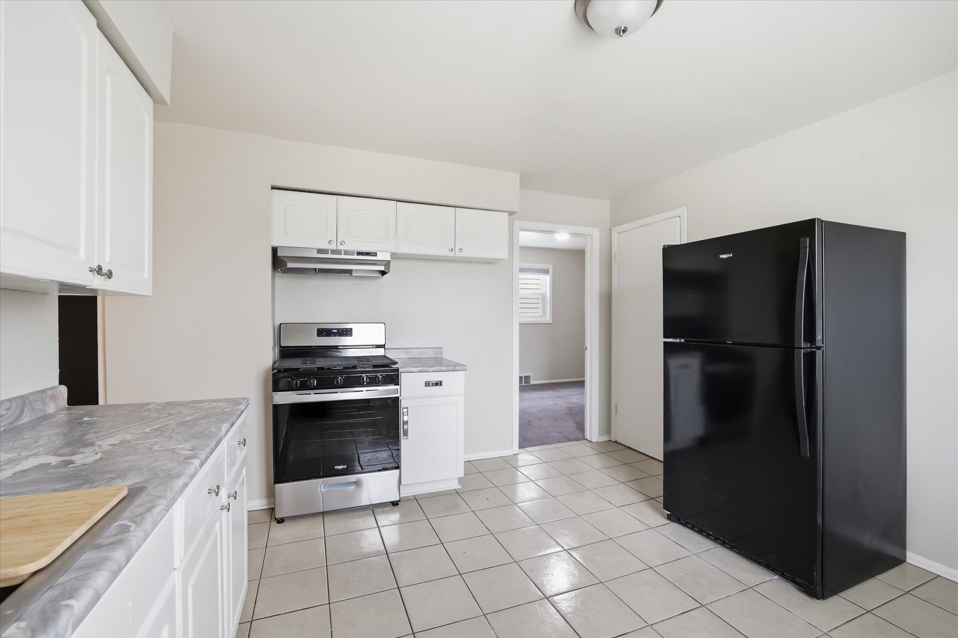 Kitchen facing pantry and Bedroom 3 - 101 W Meinecke Ave