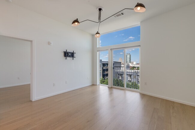 living room with TV mount and view of downtown Durham - 600 S Duke St