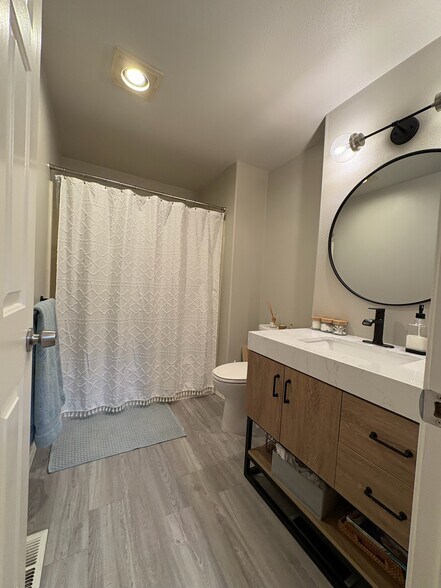 Full bathroom on second floor with tub and new vanity. - 6337 Hillman Pl NE