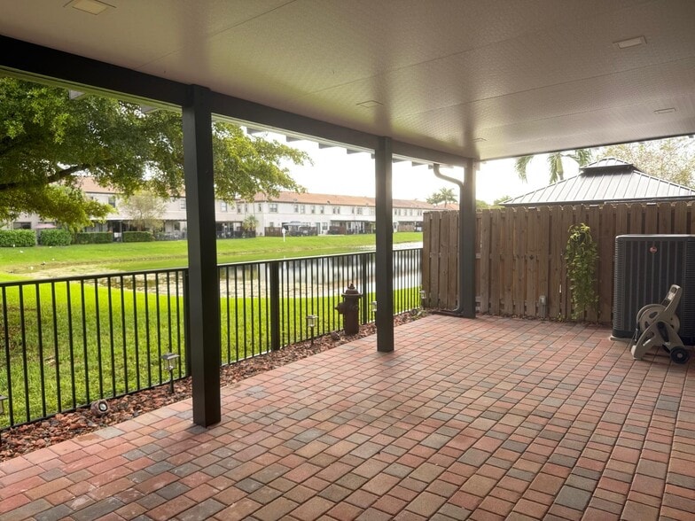 view of back patio terrace and lake - 11300 SW 236th Ln