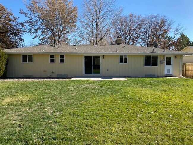 west facing rear yard with sprinklers - 2401 Dotsero Ave