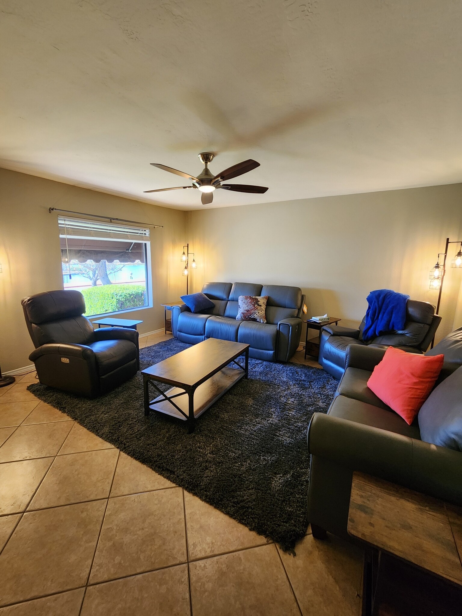 Living room features reclining Lazy-e-boy seating, Smart Roku TV and great lake views. - 5050 N 81st St