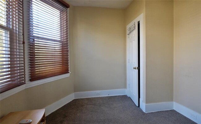 The third bedroom is a perfect size for an office or study, with a large closet and good natural light - 1109 Haslage Ave